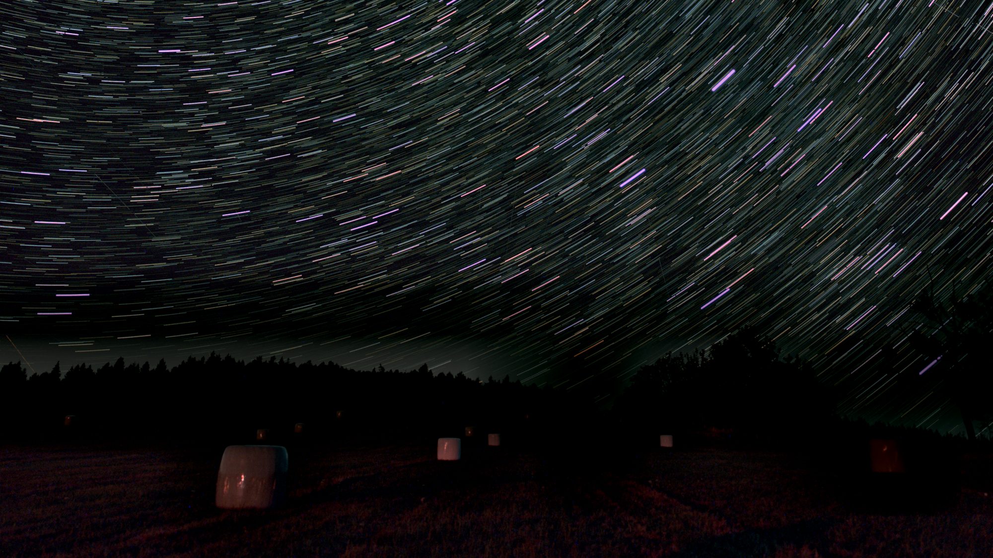 Thirty Sony A7C frames stacked with cleanup and gap filling, above a field and tree line
